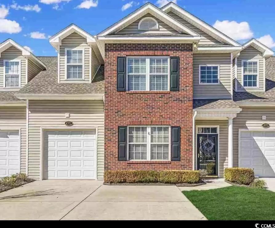 View of front of property with a garage