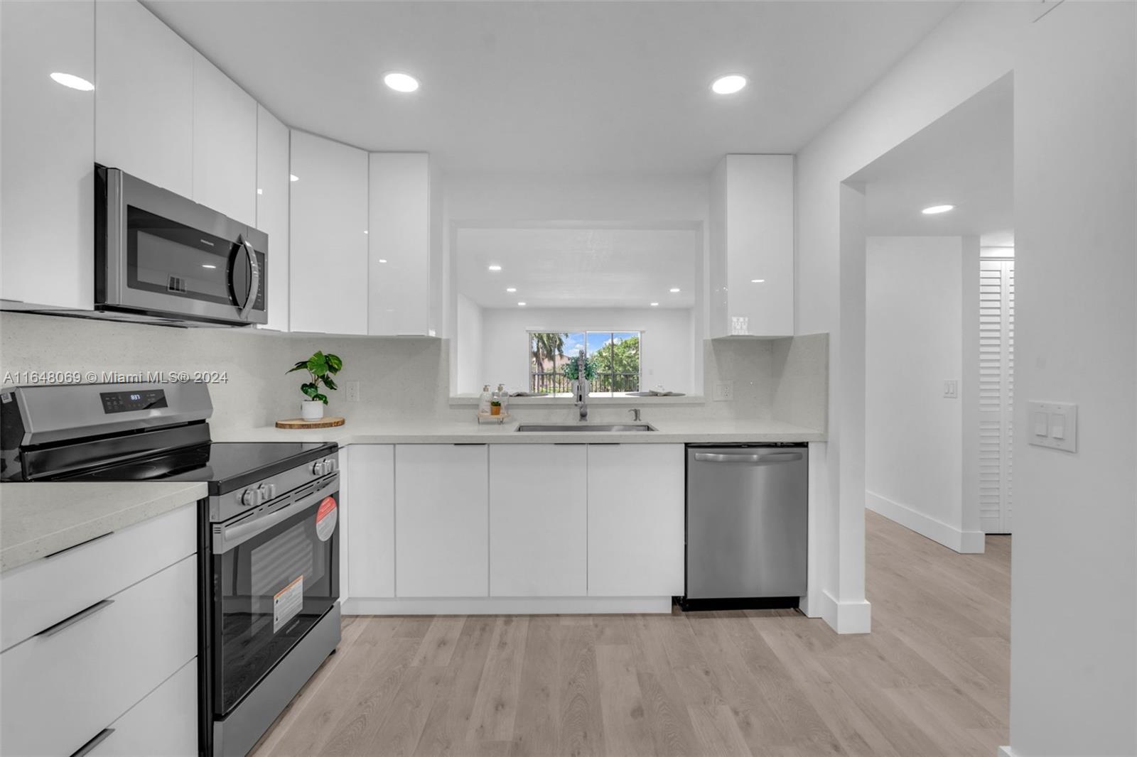 a kitchen with stainless steel appliances a stove a sink and a microwave