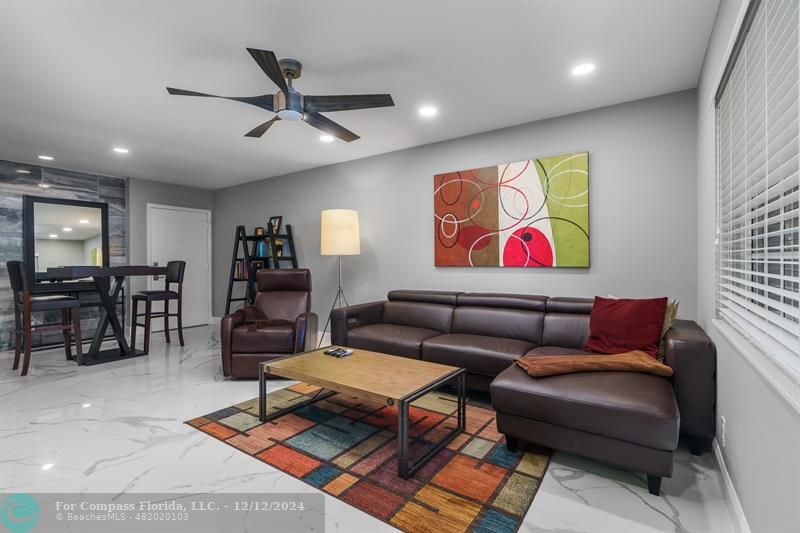 a living room with furniture and kitchen view