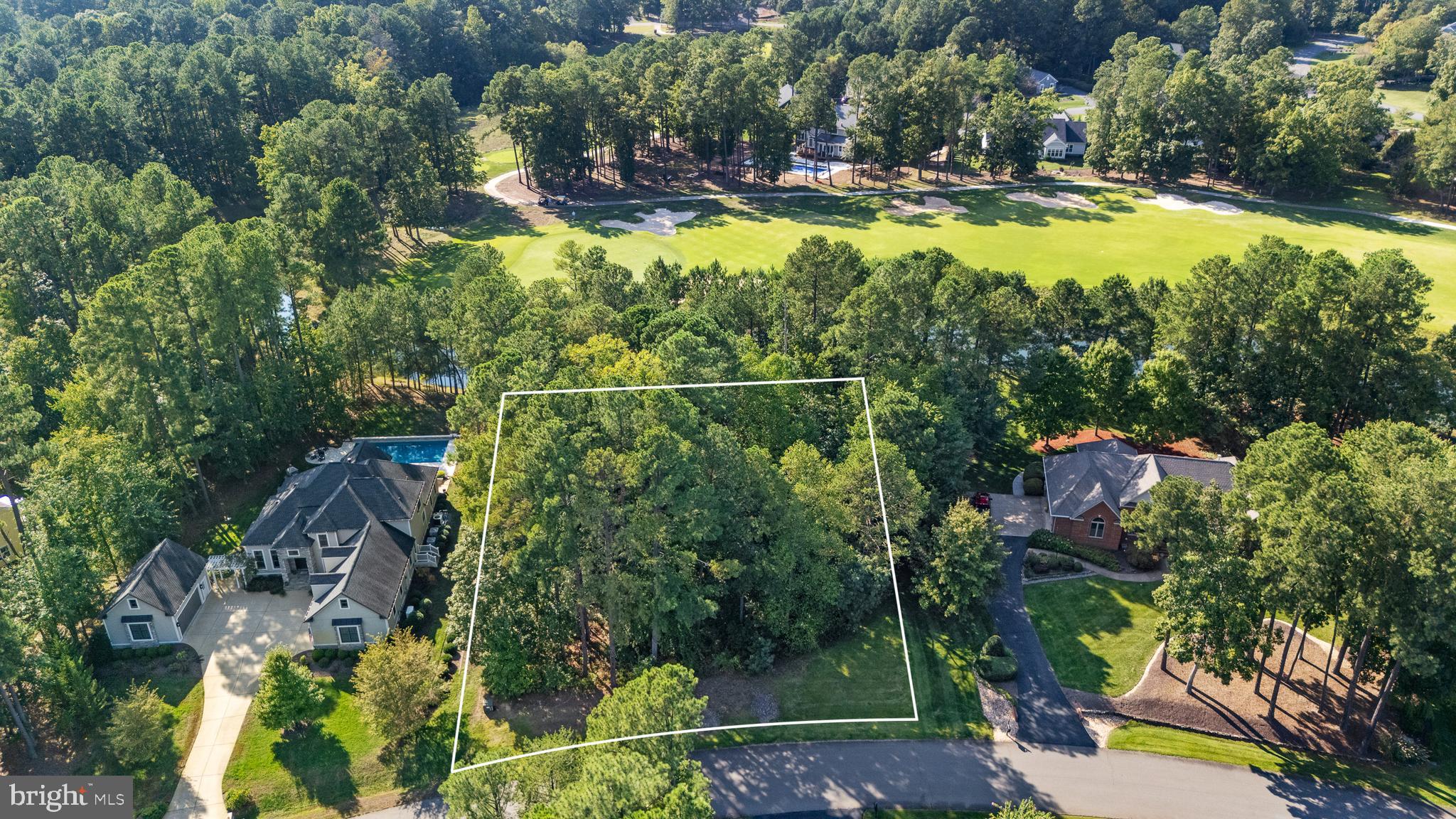 a view of a house with a yard and swimming pool