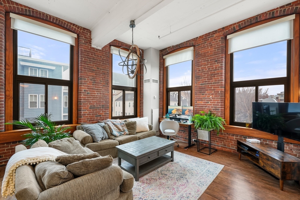 a living room with furniture fireplace and flat screen tv