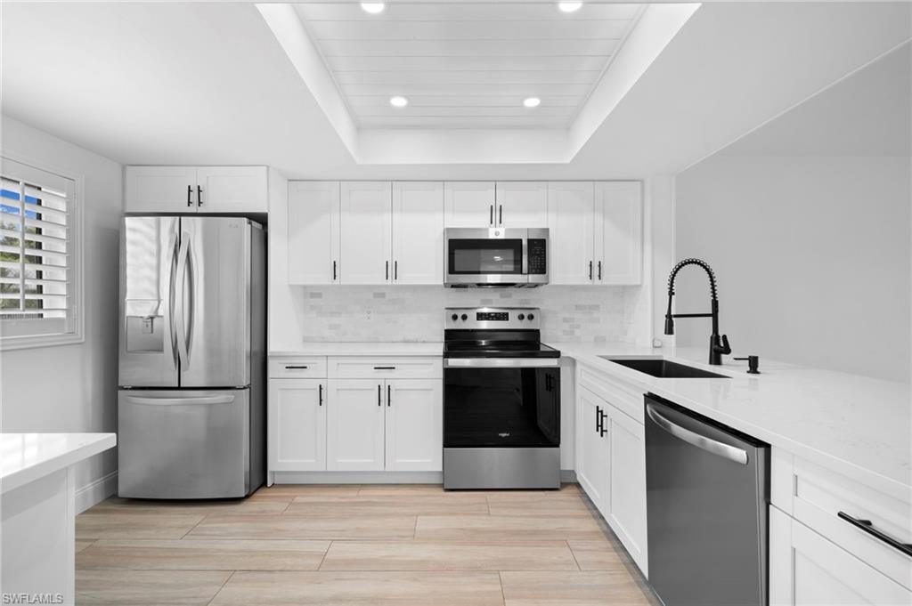 a kitchen with a refrigerator stove and microwave