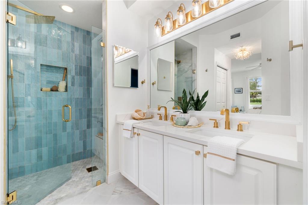 a bathroom with a sink a shower and a mirror