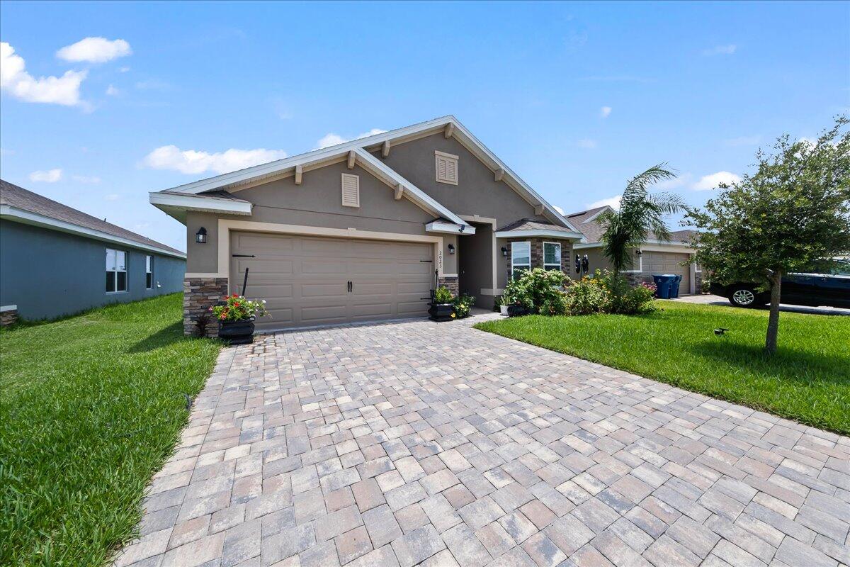 a front view of house with yard and green space