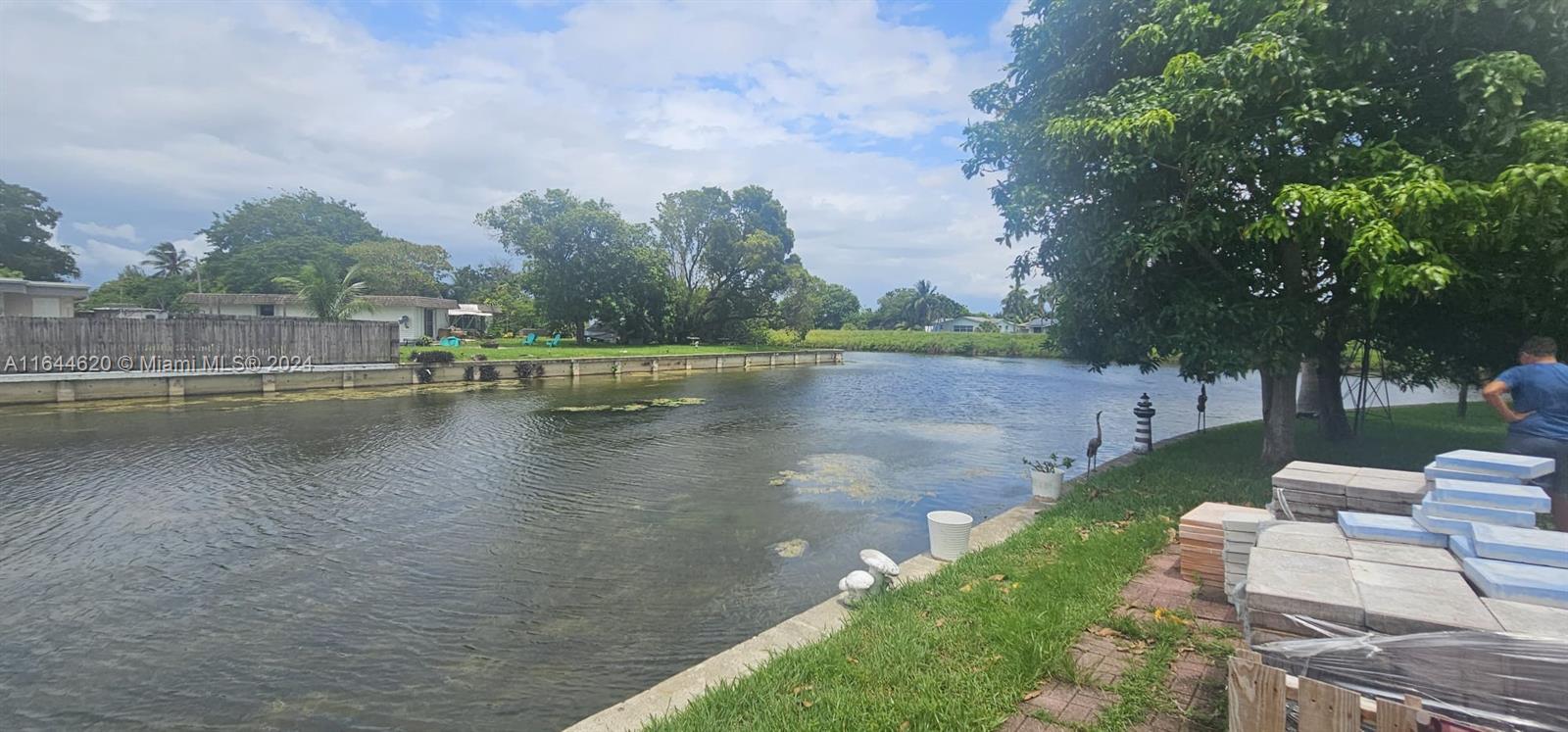 a view of a lake with houses in back