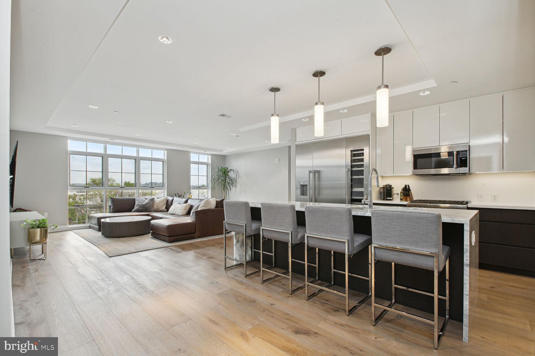 a large kitchen with lots of counter space and furniture