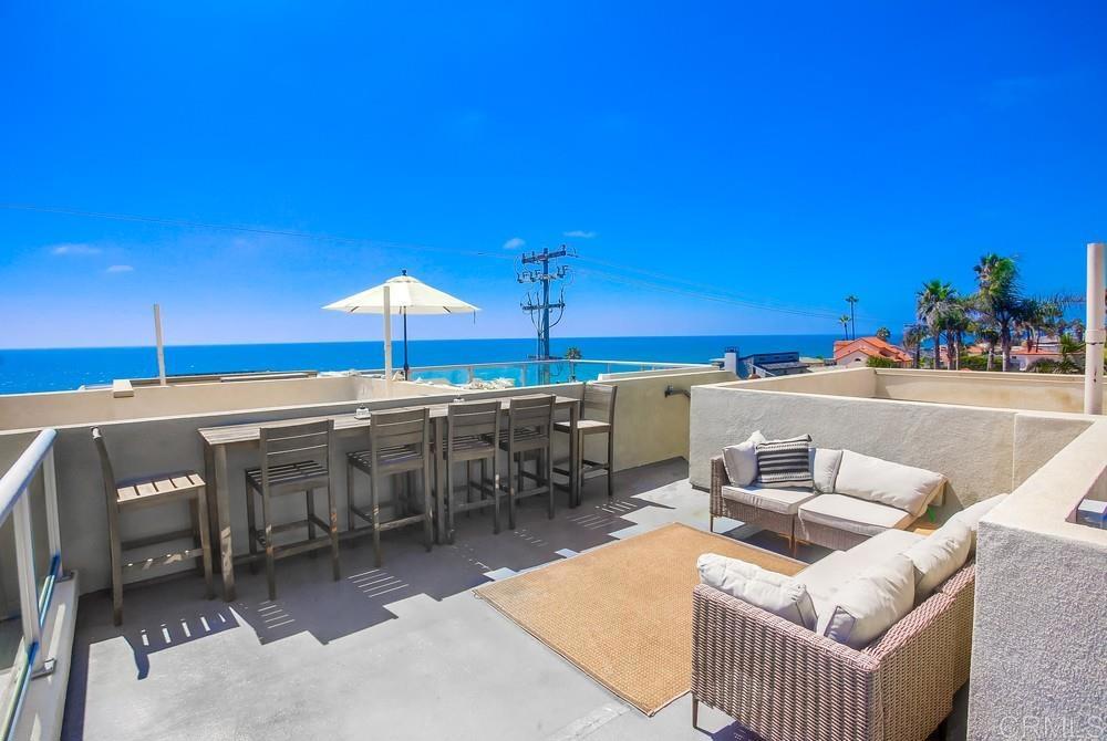 a terrace with outdoor seating and city view