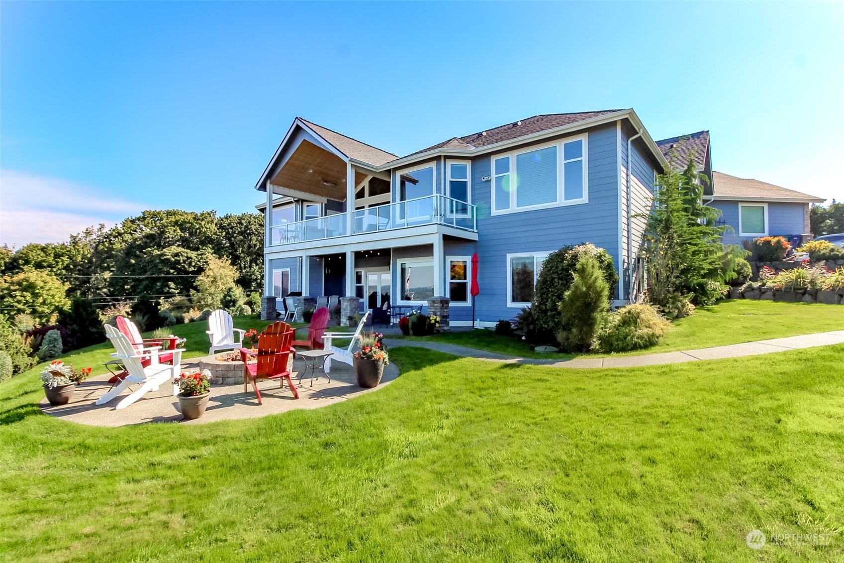 a view of a house with a yard and sitting area