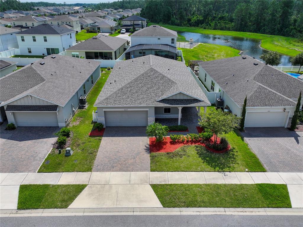 a aerial view of a house with a yard and sitting area