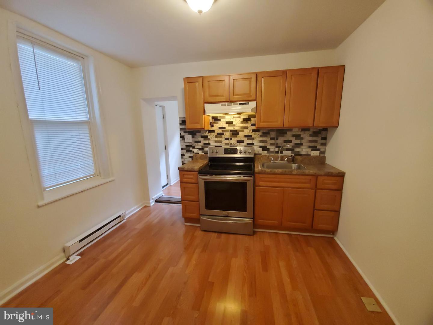 a kitchen with stainless steel appliances a stove a sink and a refrigerator