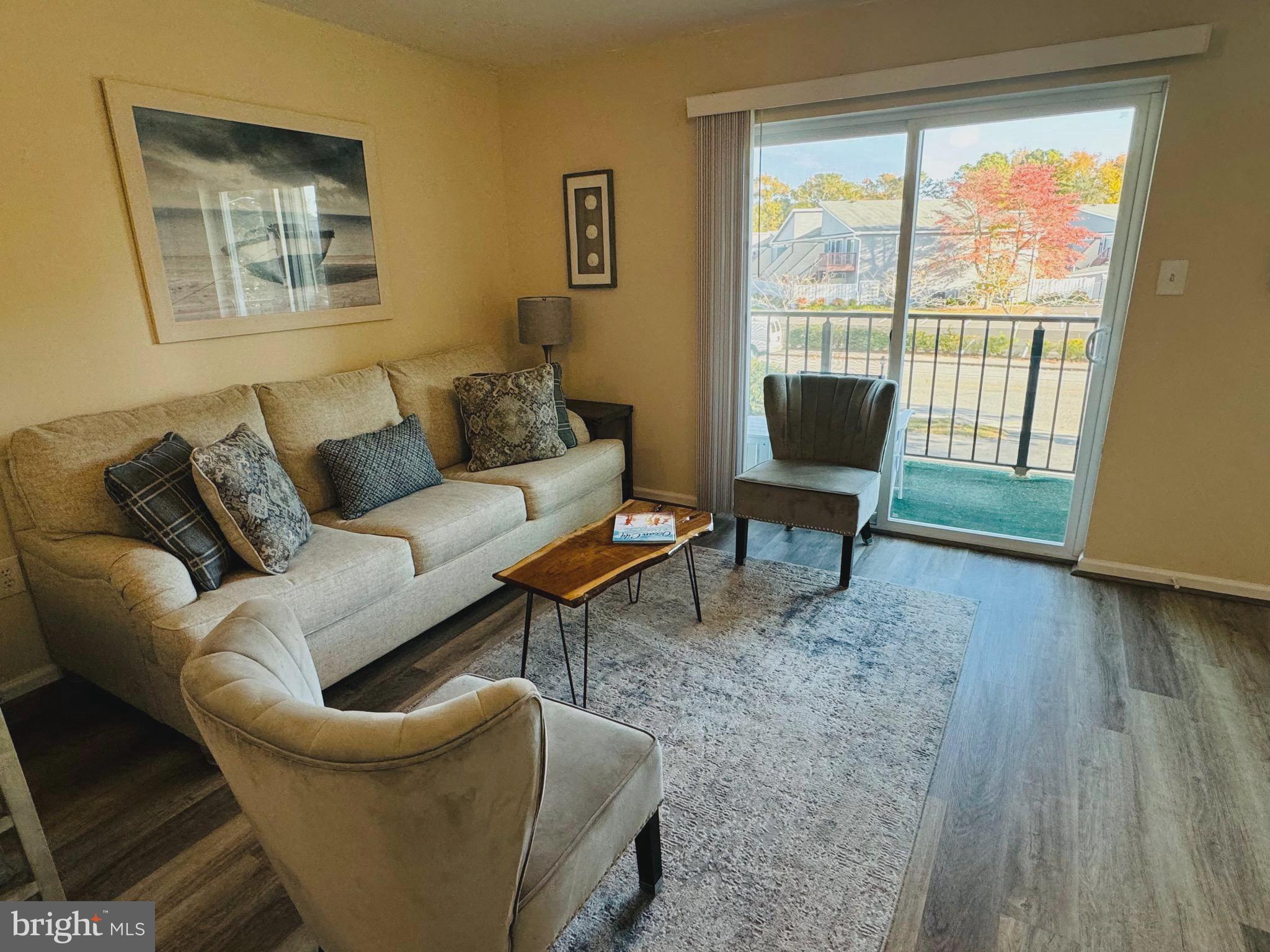 a living room with furniture and a floor to ceiling window