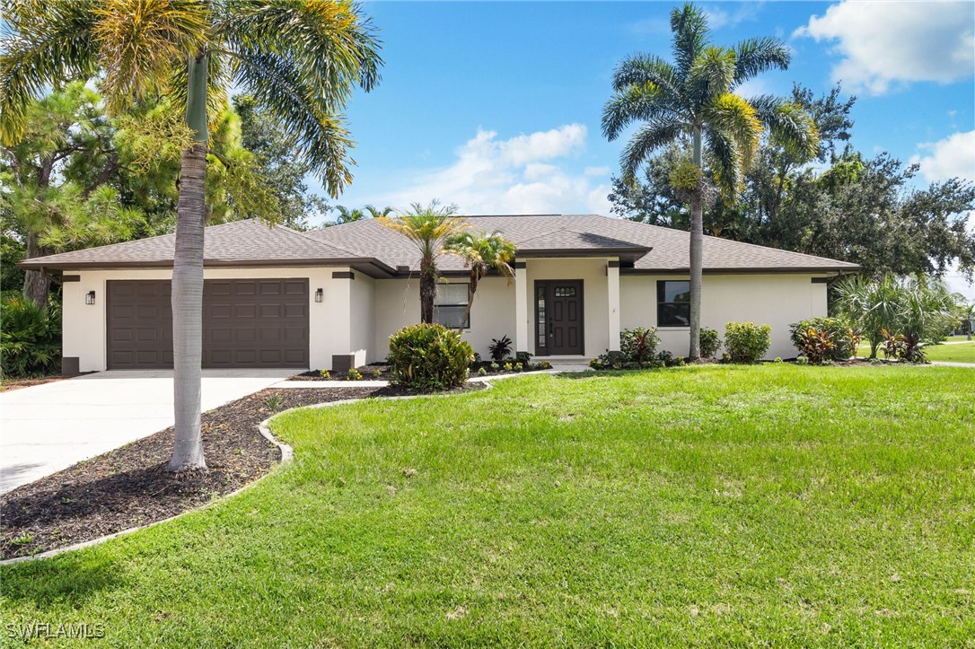 a front view of a house with a yard and garage