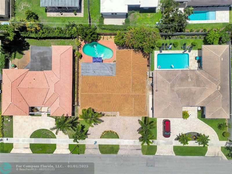 an aerial view of a house with a garden and plants