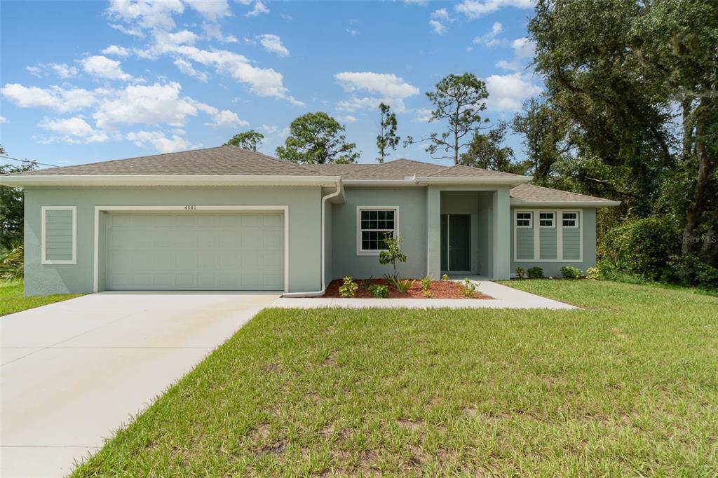 a front view of a house with a yard and garage