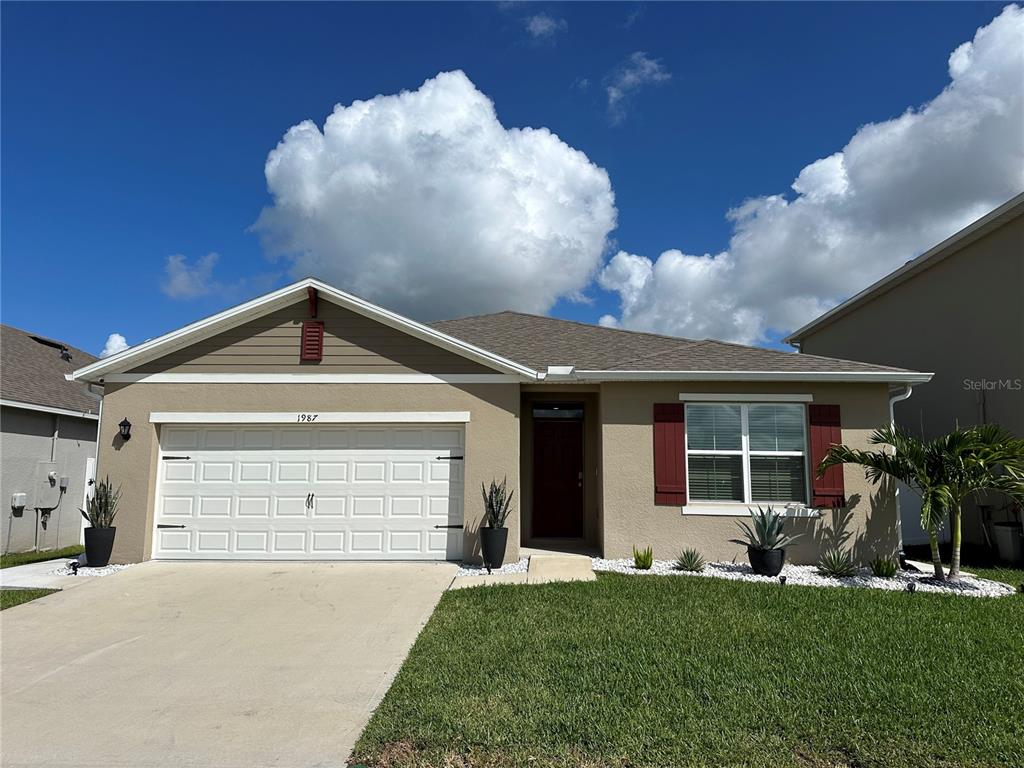 a front view of a house with a yard and garage