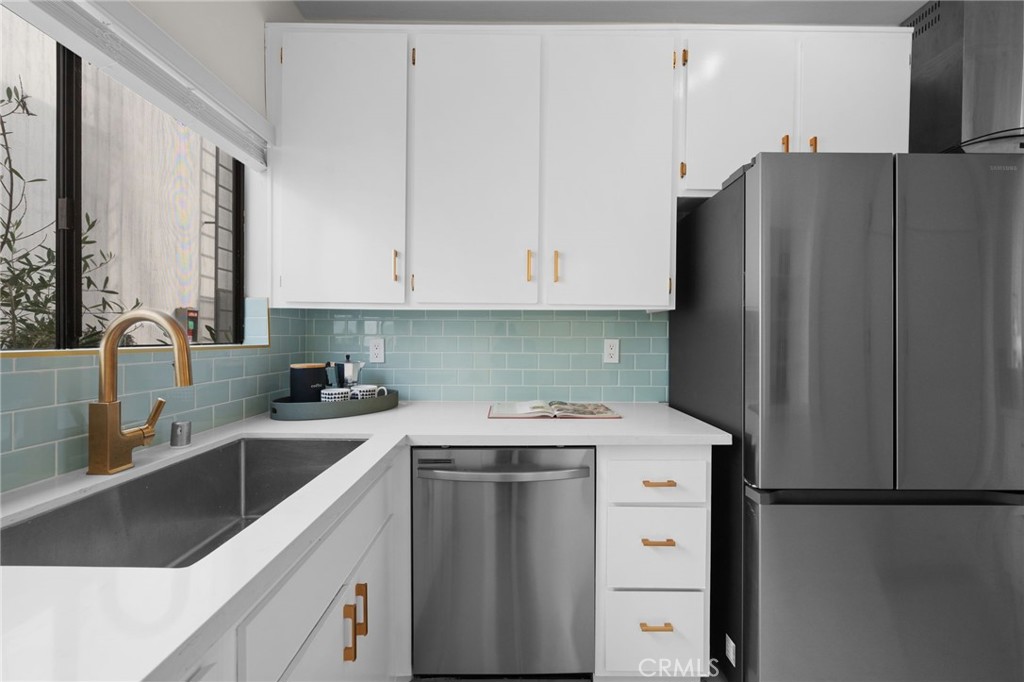 a kitchen with a white cabinets and white appliances