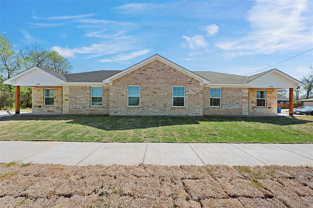 a front view of a house with a yard