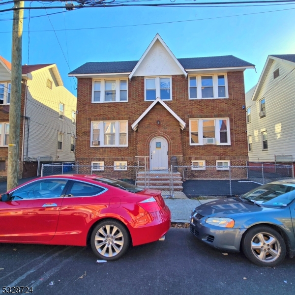 a front view of a house with parking space