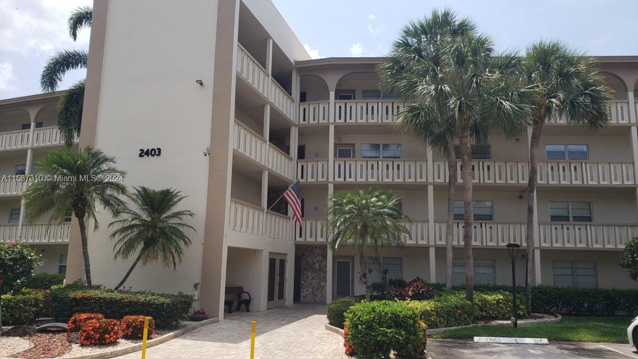 a palm tree sitting in front of a building