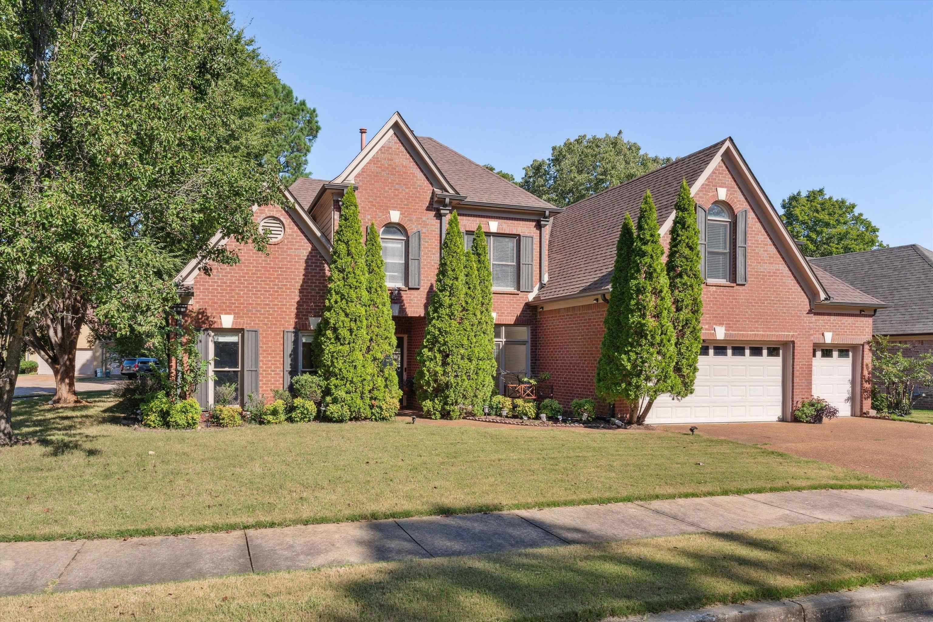 View of front of house with a front yard and a garage.