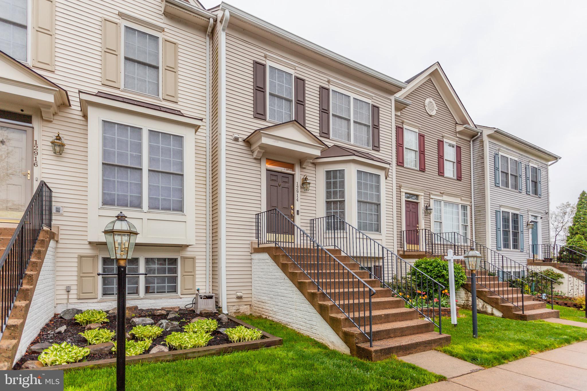 a front view of a residential apartment building with a yard