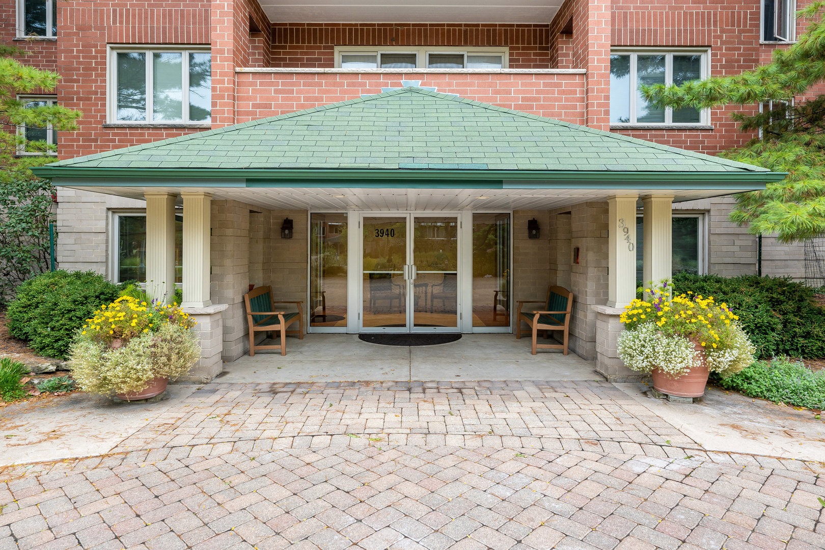 a front view of a house with a garden