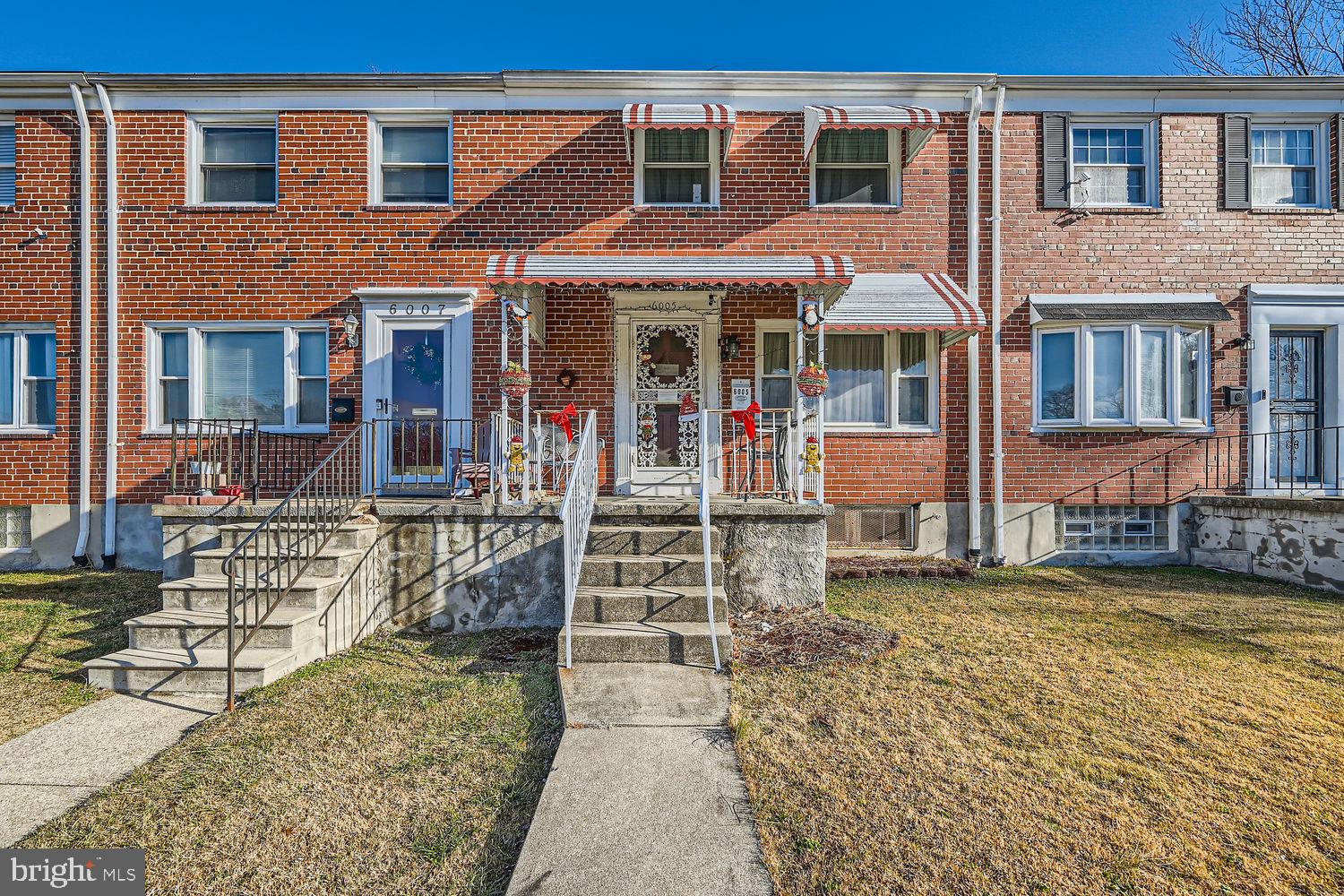 front view of a brick house with a yard