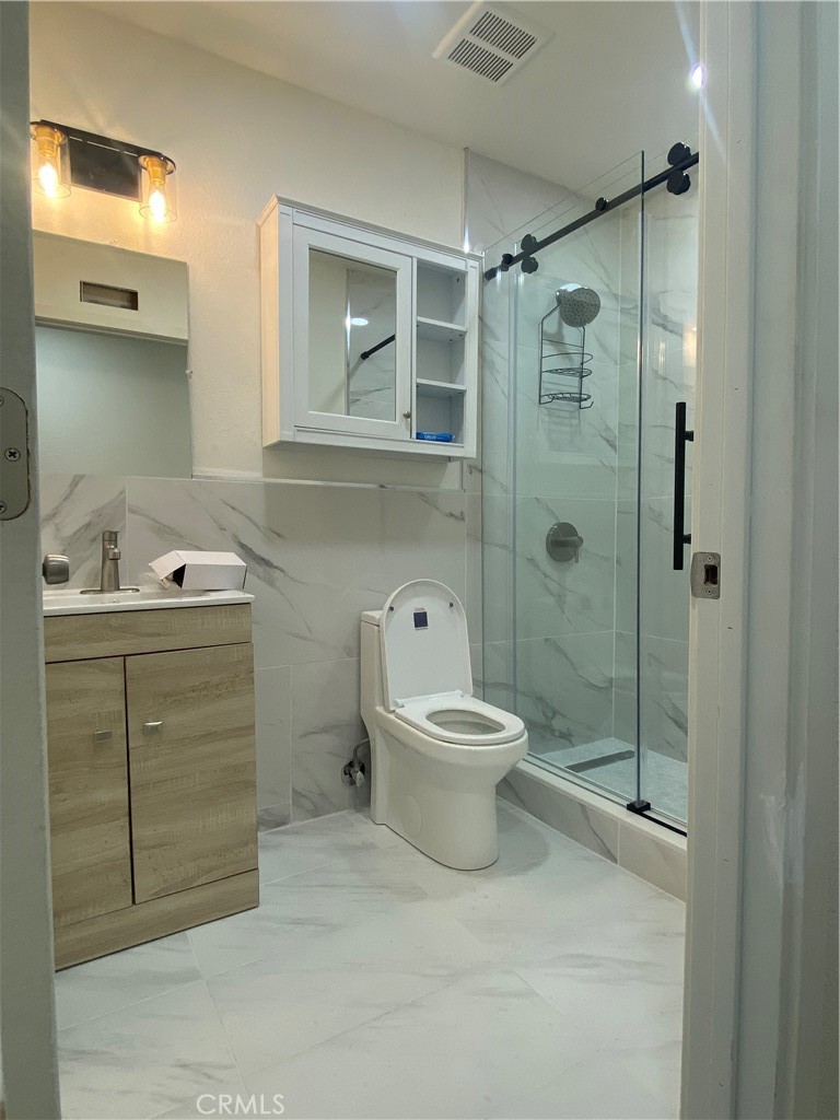 a bathroom with a toilet sink and shower