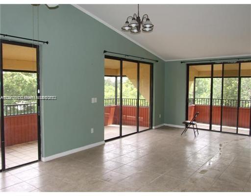 a view of an empty room with glass door