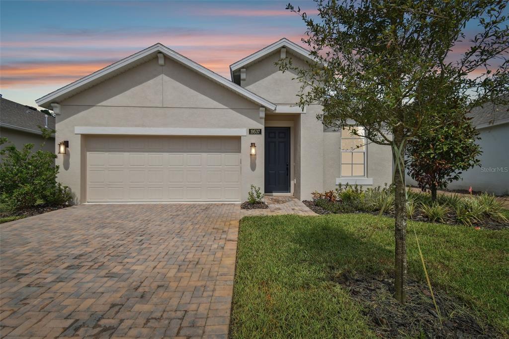 a front view of a house with a yard and garage