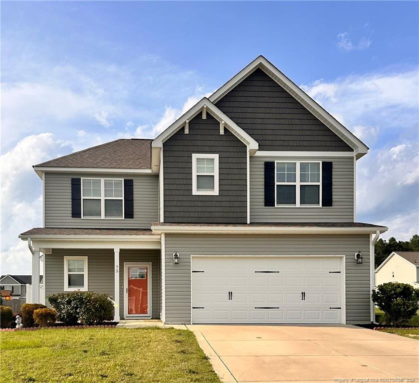 a view of a house with a yard