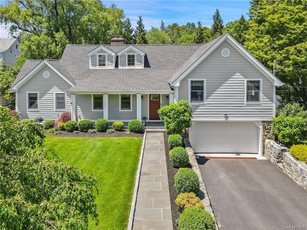 View of front of house featuring a garage and a front lawn