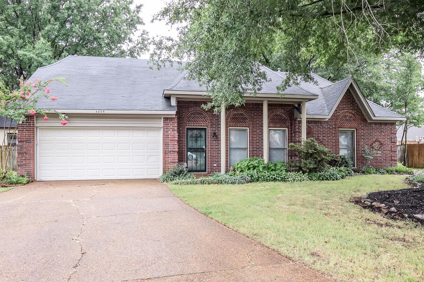 View of front facade featuring a garage and a front yard