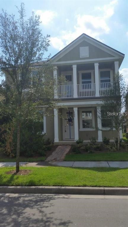 a front view of a house with a garden and yard