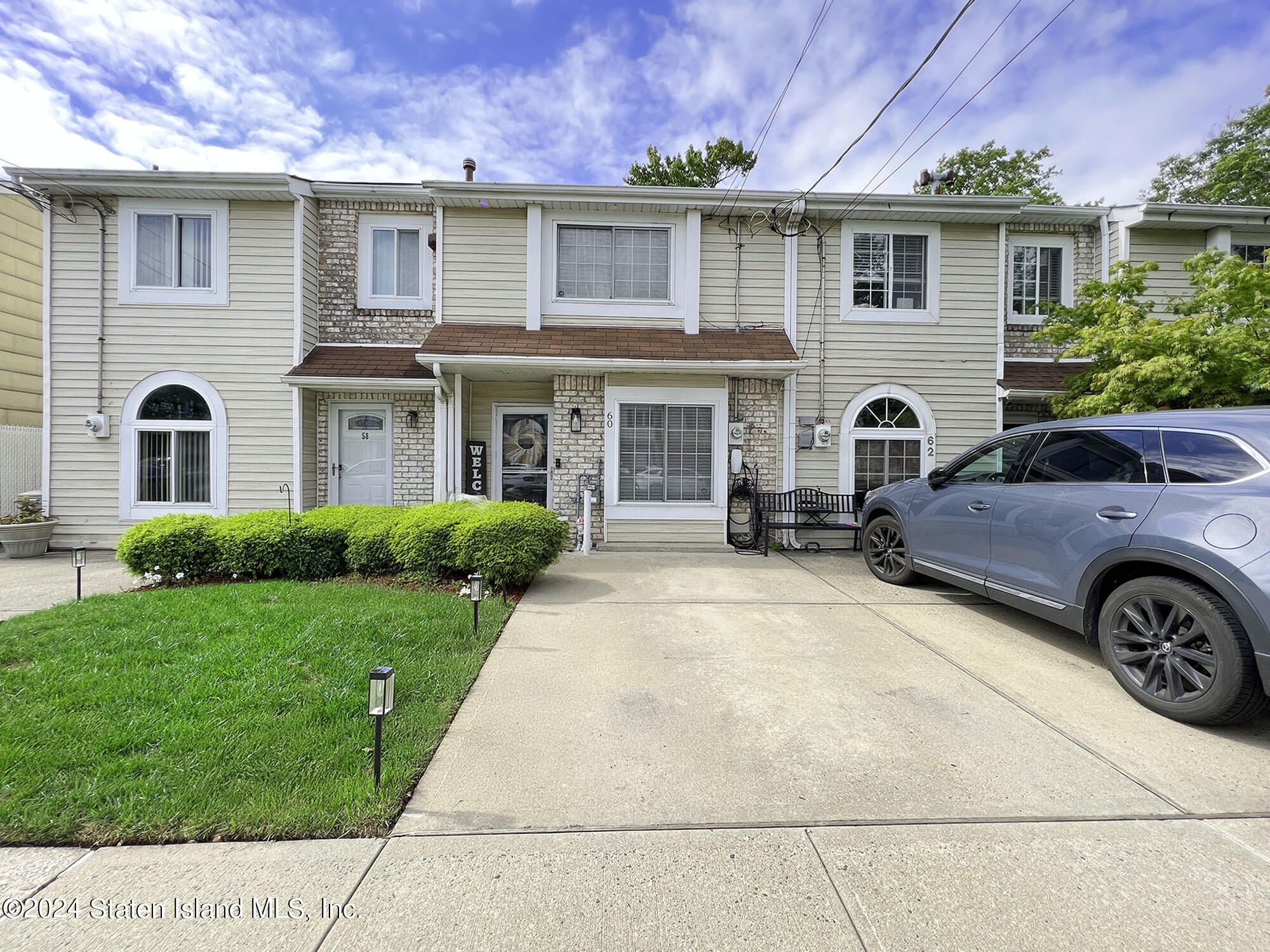 a front view of a house with a yard