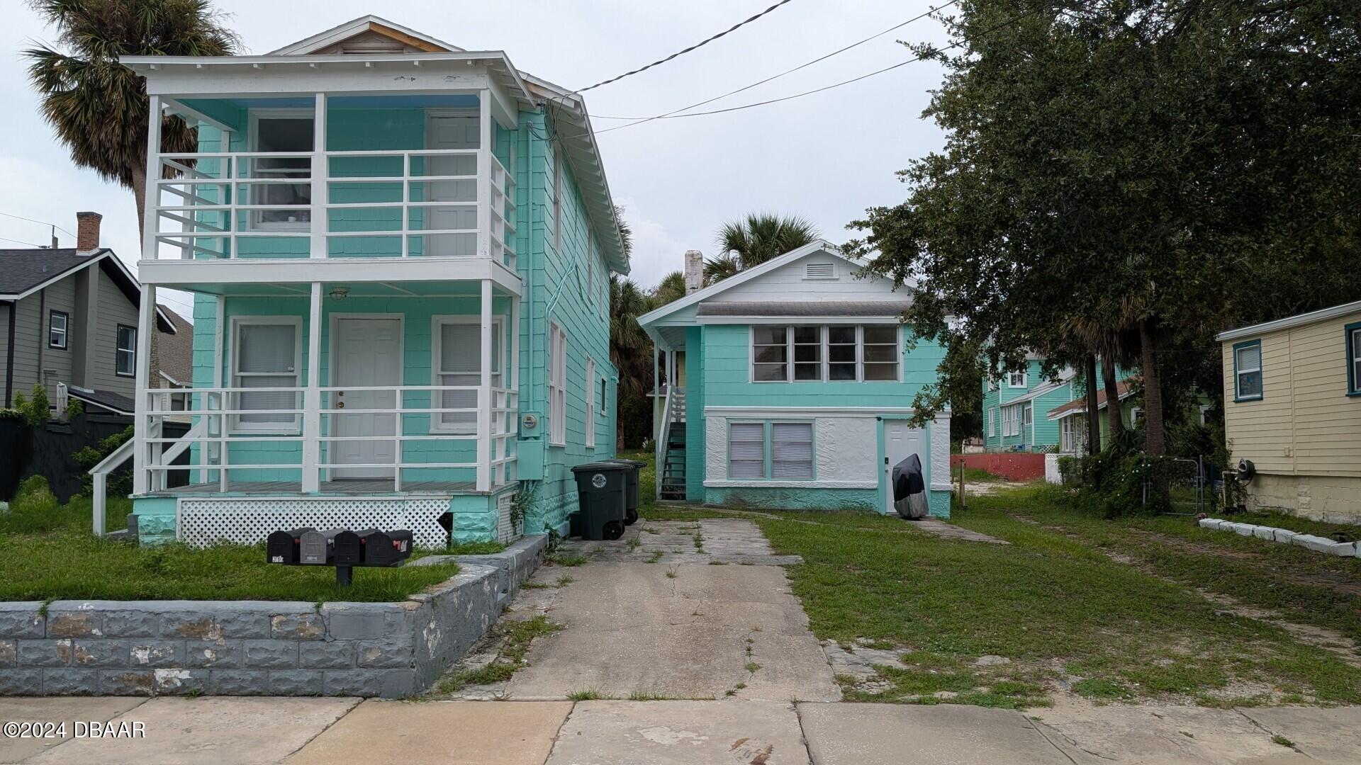 a front view of a house with a yard and porch