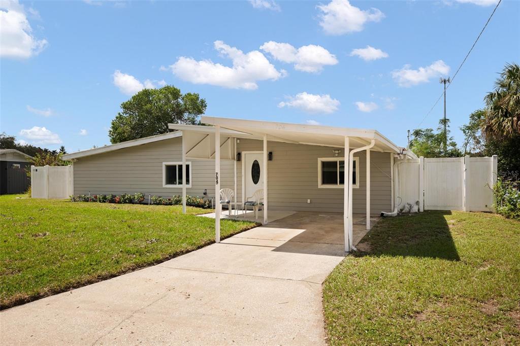 a front view of house with yard and trees