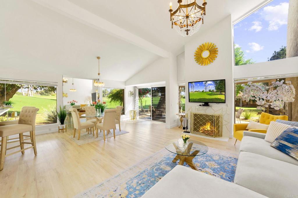 a living room with fireplace furniture and a floor to ceiling window