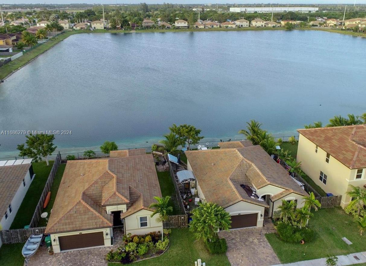 an aerial view of a house with outdoor space and lake view