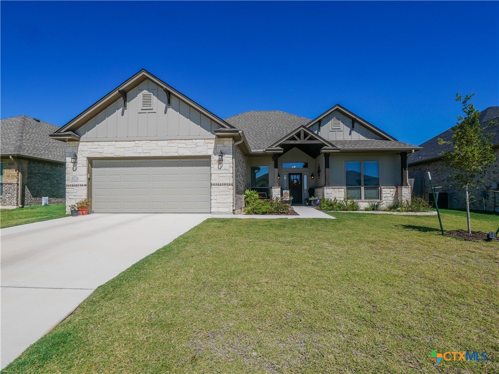 a front view of a house with a yard and garage