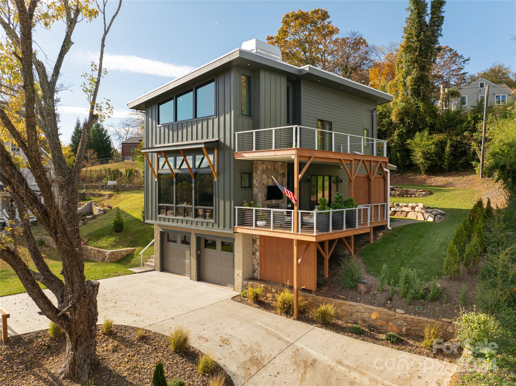 a view of a house with a wooden deck and a yard