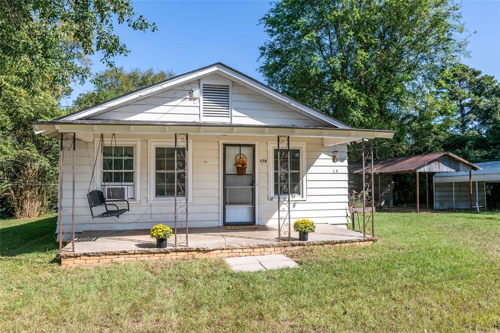 a front view of a house with a yard and porch