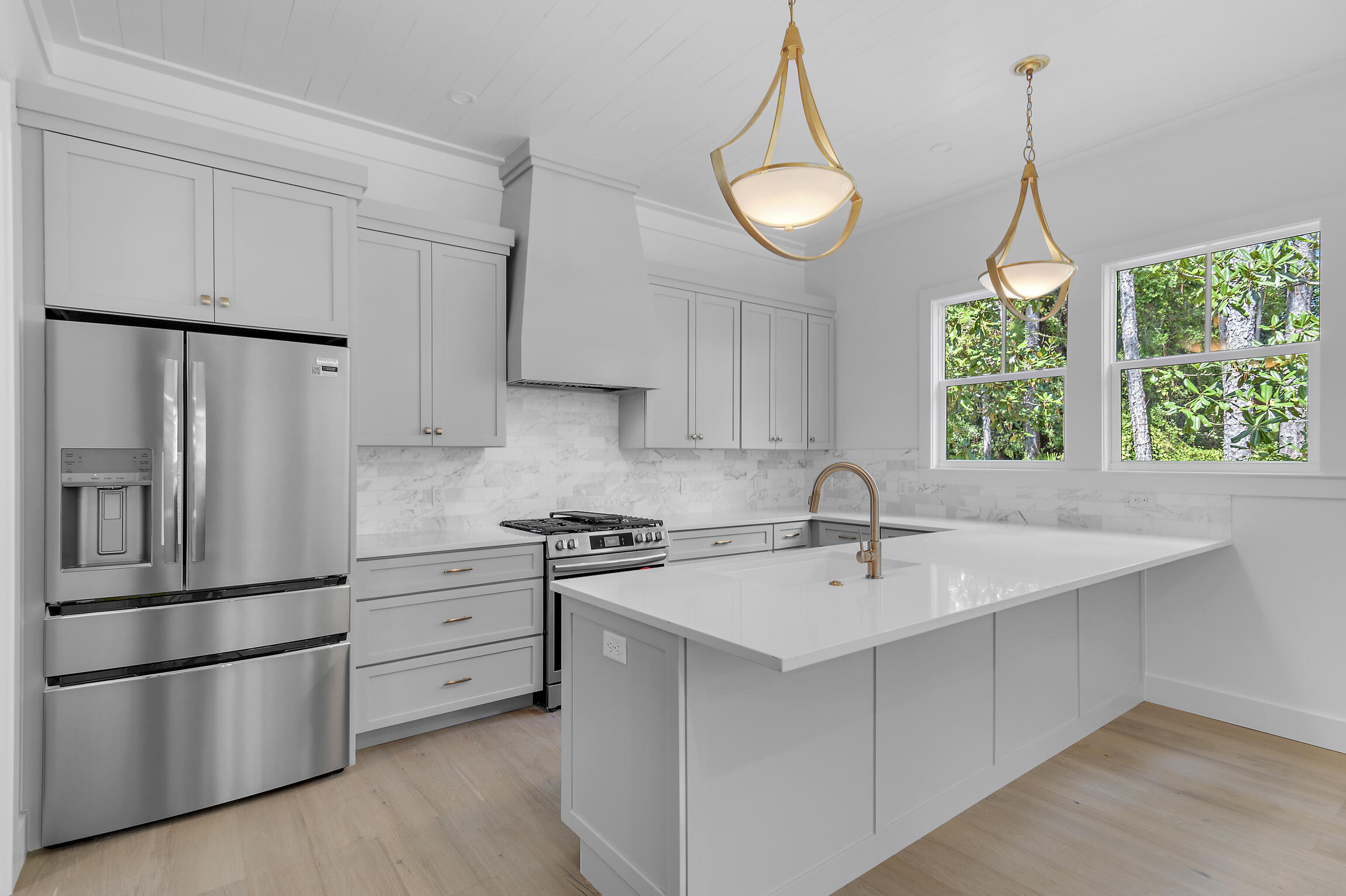 a kitchen that has a sink stainless steel appliances and cabinets