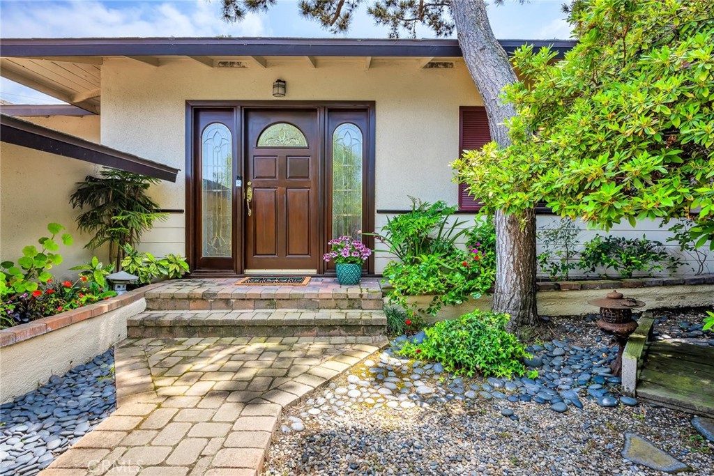 Private front entrance surrounded by a beautiful garden and mature trees