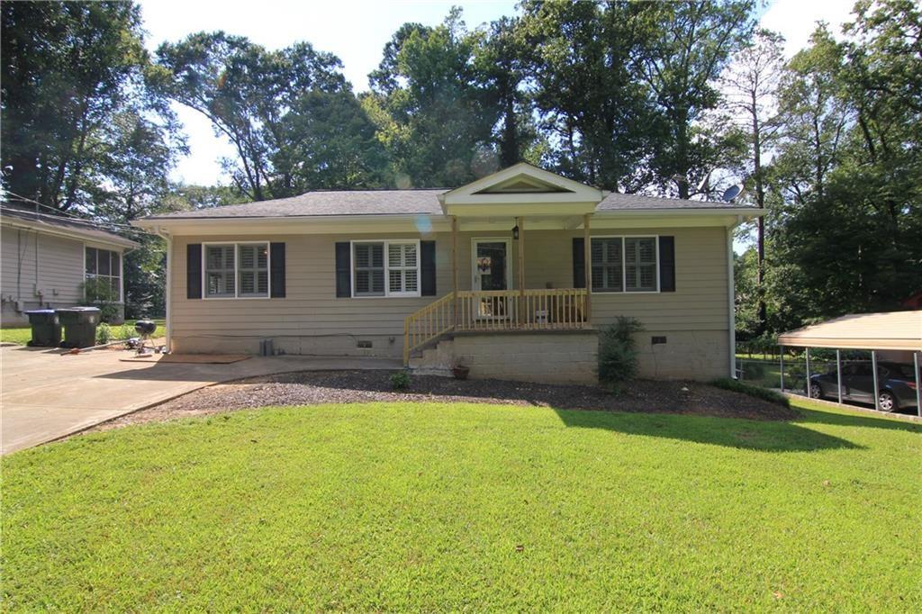 a front view of a house with a yard table and chairs