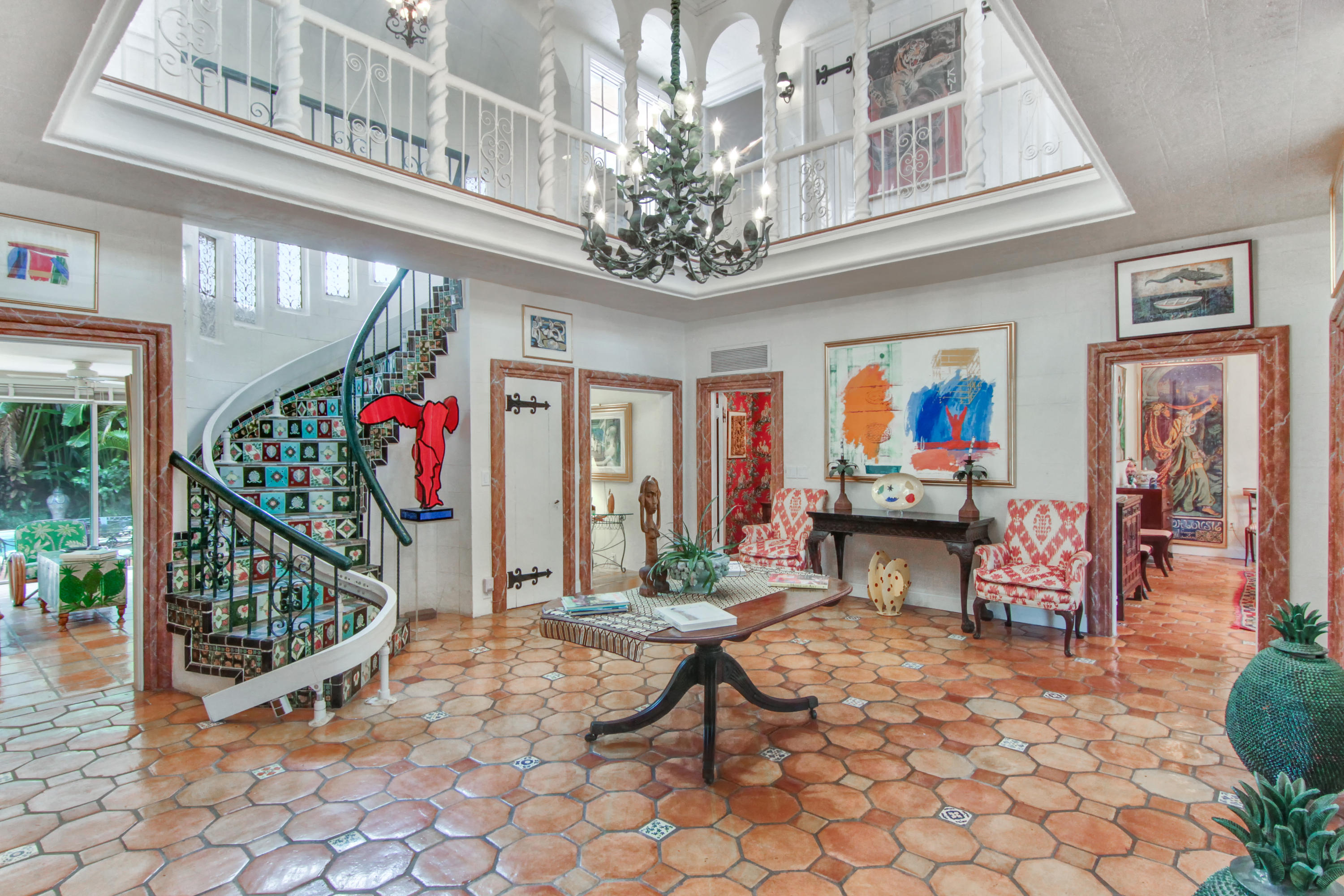 a view of a hallway with a dining table chairs and entryway