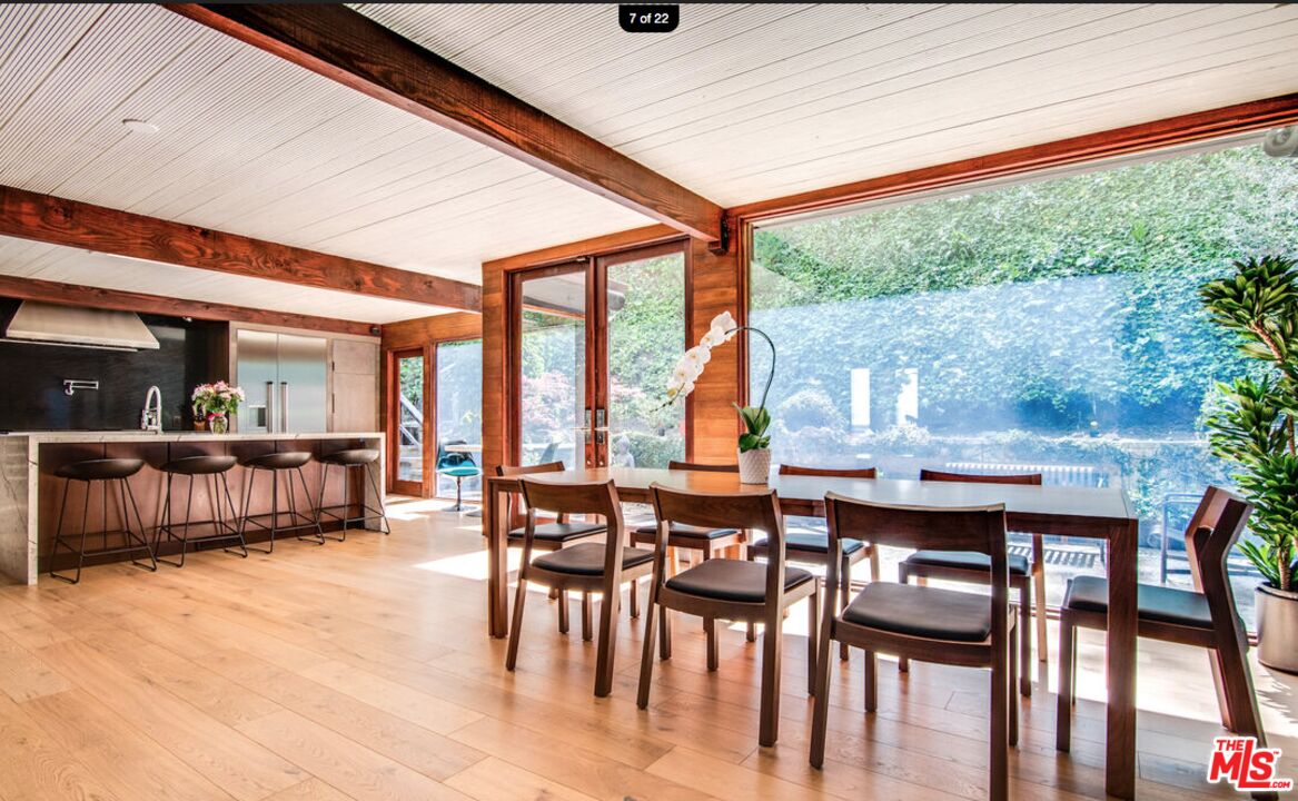 a dining room with furniture window and wooden floor