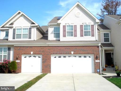 a front view of a house with a garage