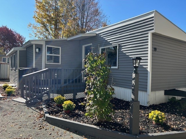 a front view of a house with a yard and plants