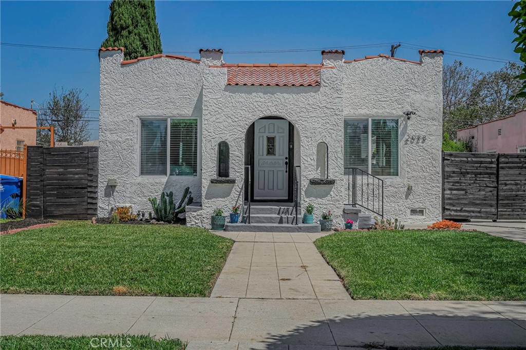 a front view of a house with a garden